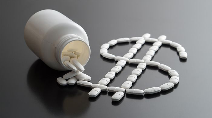 Image of pills arranged to make a dollar sign