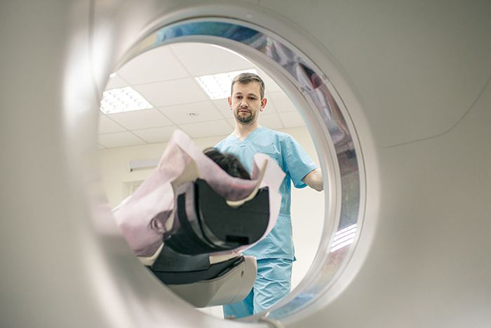 Image: Doctor looking at patient laying in MRI