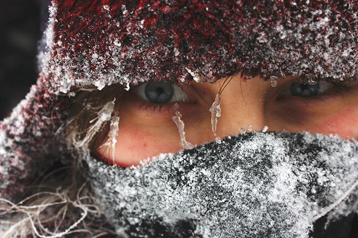 Closeup of a woman's face covered in ice 