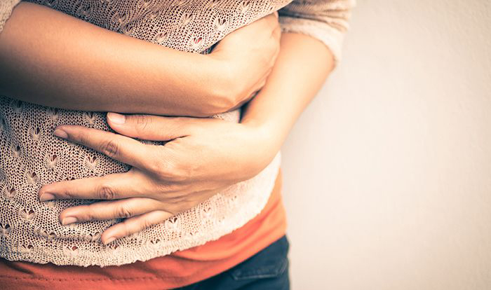 Woman holding stomach