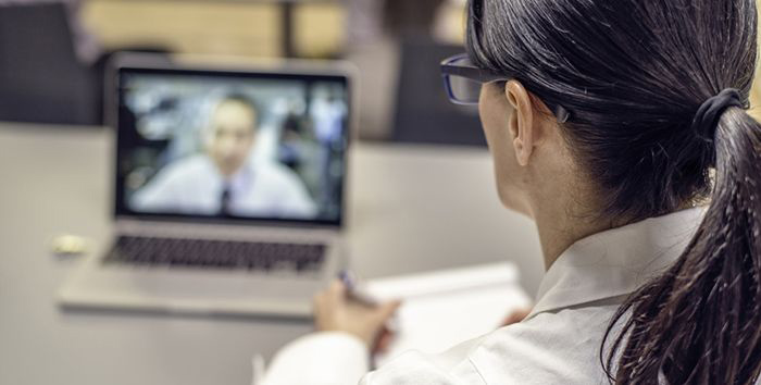 Doctor speaking with patient using a laptop