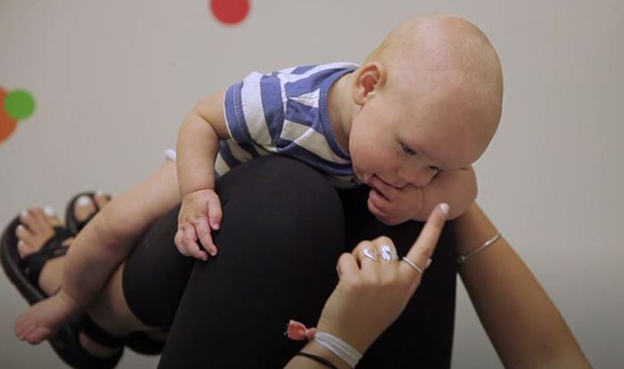 Image: mother playing with infant