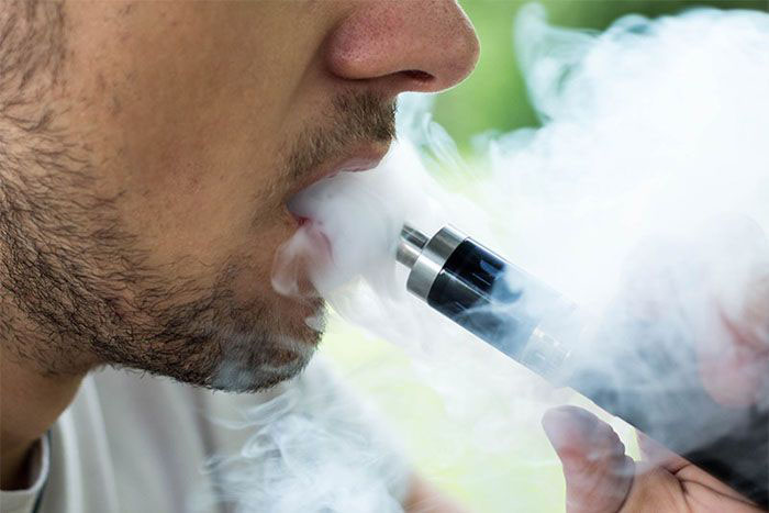 Image: Young man vaping