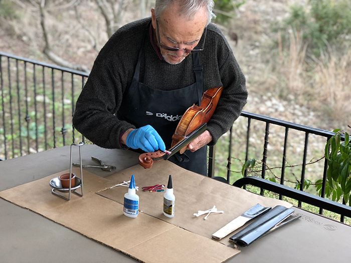 Image: Joseph Nagyvary applies glue to a violin fingerboard.