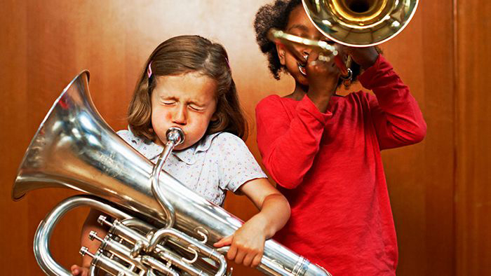 Two young girls playing instruments