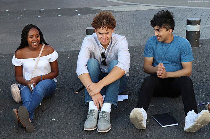 Above: Mechanical engineering major, Peace Mutwiri, manufacturing and design engineering major, Cole Seabrook, and industrial engineering major, Aarij Rehman lead a group discussion on the sidewalks of Hamburg Germany.
