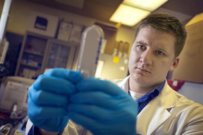Henry Towery investigates the results of a blood test for a clinical research study.