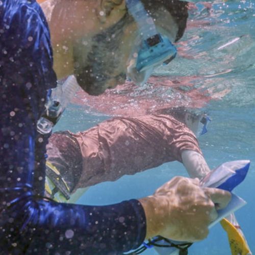 Nathaniel Buescher, checks GPS coordinates while searching for coral samples.