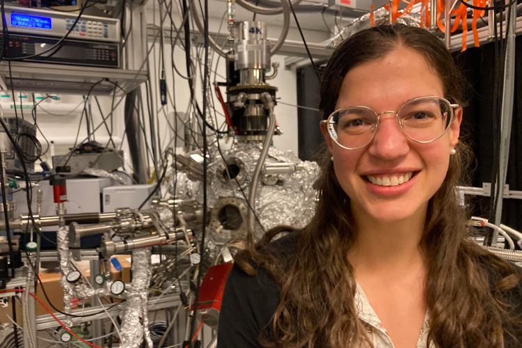 "Surprisingly simple explanation for alien comet ‘Oumuamua’s weird orbit; Photo: Jennifer Bergner in her Ph.D. lab at Harvard University. In the background is instrumentation for studying ice chemistry at the frigid temperatures characteristic of interstellar space. (Photo credit: Luke Kelley)"