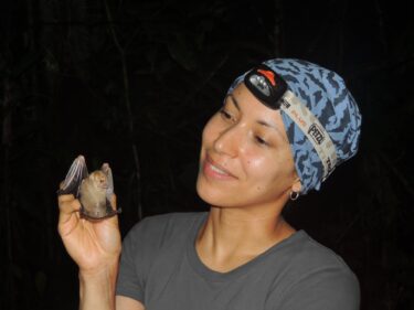 "The many faces of bats; PictureofSharlene Santana holding a bat"