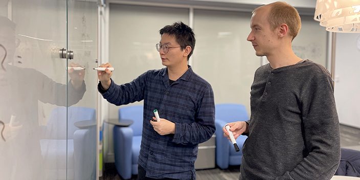Proposed quantum device may succinctly realize emergent particles such as the Fibonacci anyon; Guangjie Li, graduate student, and Dr. Jukka Vayrynen, assistant professor of physics and astronomy, discuss calculations at the Purdue University Physics Building."