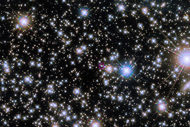 "Bright gamma ray burst confounds models of black hole birth; Photo: The Hubble Space Telescope’s Wide Field Camera 3 revealed the infrared afterglow (circled) of the gamma ray burst and its host galaxy, seen nearly edge-on as a sliver of light extending to upper right from the burst"