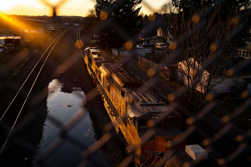 "Texas A&M, Carnegie Mellon Researchers Confirm EPA’s Finding On Air Quality In East Palestine; A Norfolk Southern train passes underneath a bridge on Feb. 25. in East Palestine, Ohio. "