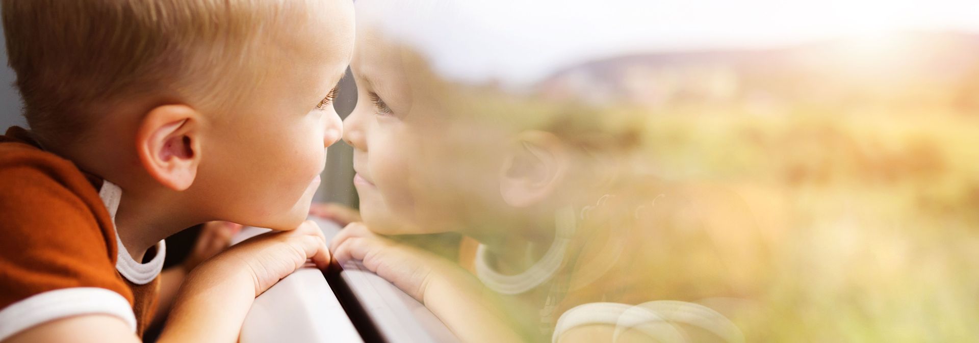"Through the eye of the beholder: People with autism may process illusory shapes differently; stockphoto of child looking out window.