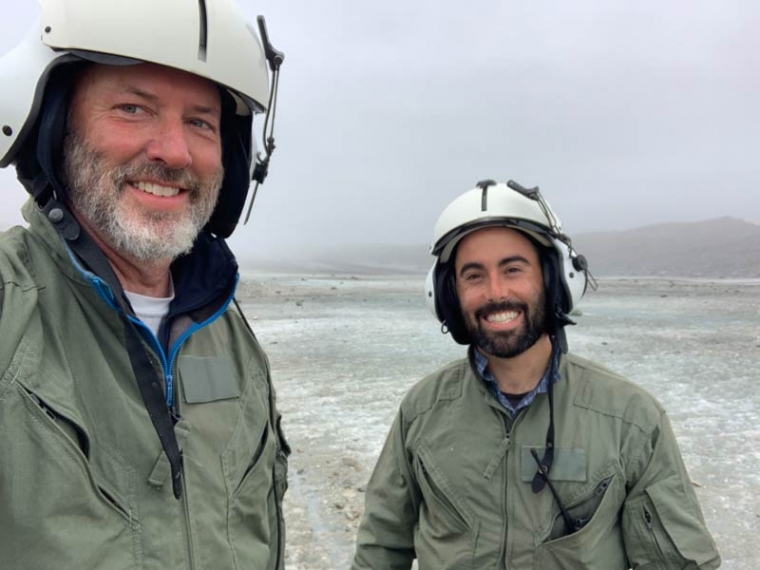 "3D radar scan provides clues about threats to iconic Alaskan glacier; Donning flight suits, Jack Holt (left) and Brandon Tober await a helicopter ride back to base camp after completing a geophysical survey on Malaspina Glacier.Jack Holt/University of Arizona"