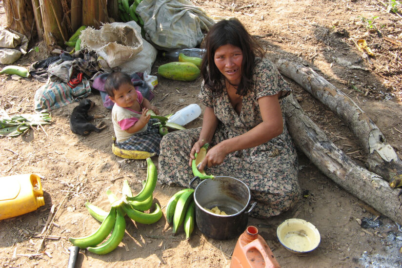 For clues to healthy brain aging, look to the Bolivian Amazon; Picture: Tsimané woman with child peeling plantains.