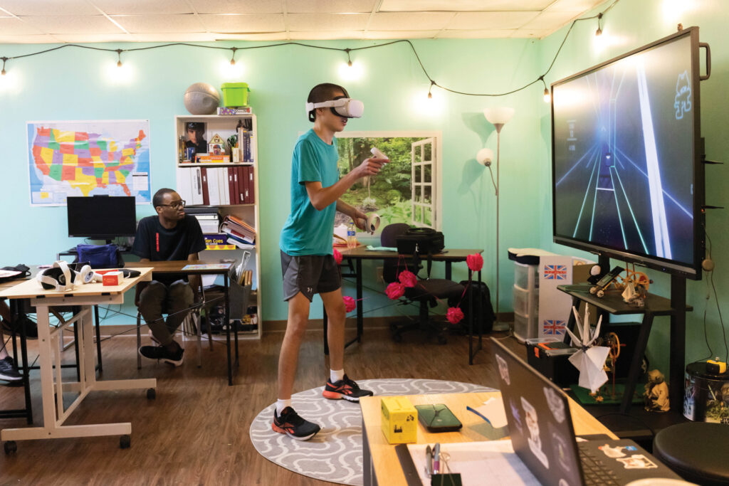 "It Makes Us Feel Powerful: Unlocking Virtual-Reality's Potential for People With Autism; Reach Academy graduate Ethan Anderson plays a VR game in the Jacksonville school’s transition classroom as classmate Dallas Roberson looks on"