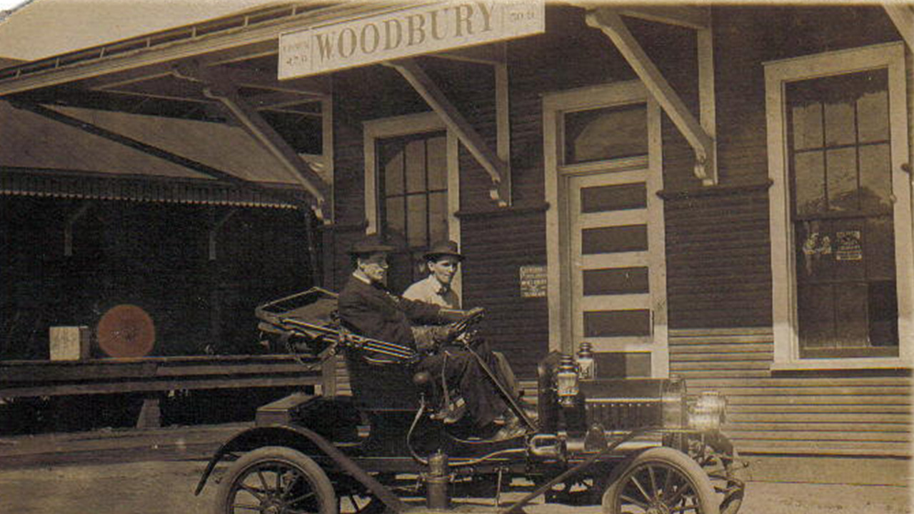 "Georgia Tech Helps Rebuild Former Pimento Capital of the World; Two men sit in a motor vehicle on Main Street in Woodbury in 1931."
