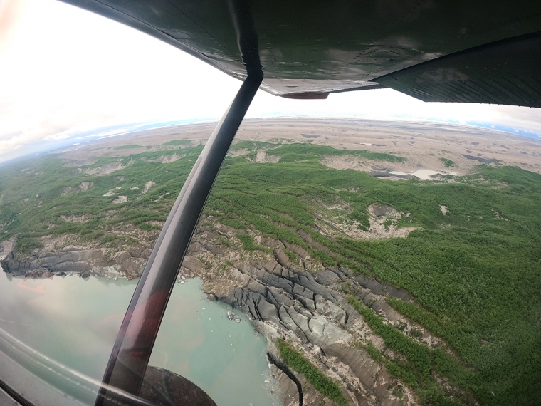"3D radar scan provides clues about threats to iconic Alaskan glacier; Vegetation growing atop massive ground ice – a crevassed forest – is seen in this aerial photo of the land strip that separates Malaspina Glacier from the Pacific Ocean. This coastal barrier "wastes away," the researchers say, as ice cliffs collapse and form a growing expanse of lagoons. Brandon Tober/University of Arizona"