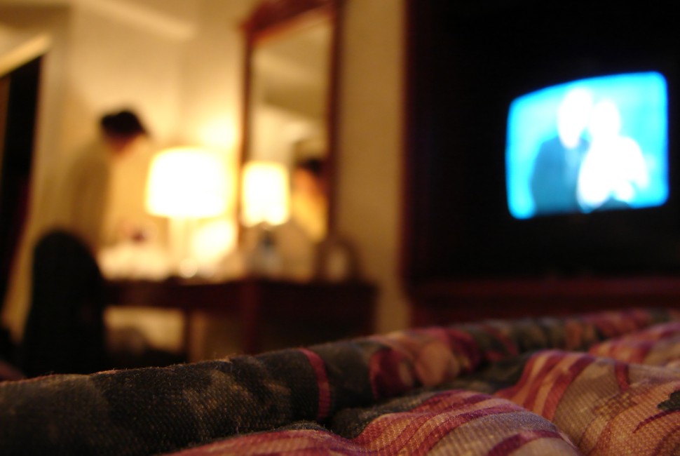 Dim Lights Before Bedtime to Reduce Risk of Gestational Diabetes; Photo: Blurry image of woman standing over a vanity desk with the tv on