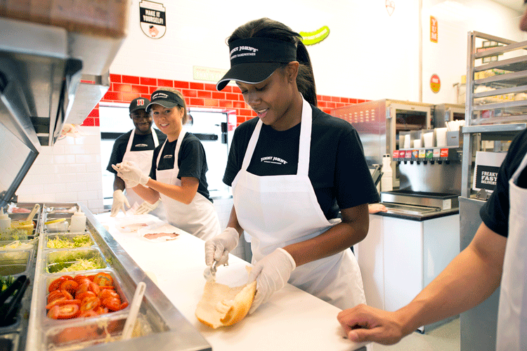 Even in Small Businesses, Minimum Wage Hikes Don’t Cause Job Losses, Study Finds; Picture: People behind Jimmy John's counter making sandwiches