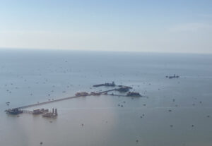 "; Central-hub multi-platform complexes in the Gulf of Mexico emit far more methane than official inventories report, according to a study led by the University of Michigan. Researchers flew over the region in a Mooney airplane to measure greenhouse gas emissions. This photo, from one of their flights, shows a central hub collecting oil and gas from surrounding smaller satellite production platforms. Image courtesy: Paolo Wilczak."