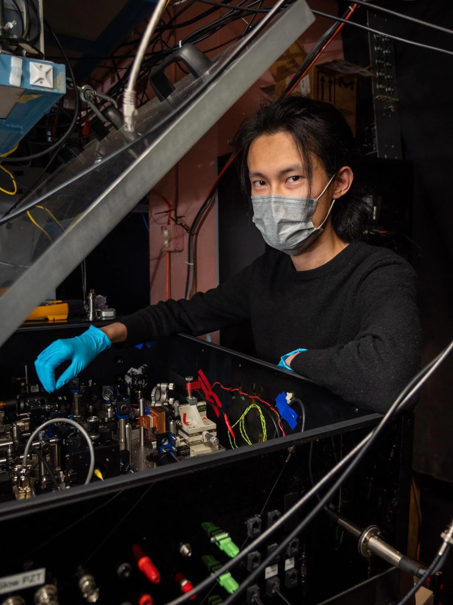 "New laser-based breathalyzer sniffs out COVID, other diseases, in real-time; Qizhong Liang, a PhD candidate in JILA and the Department of Physics. Credit: Patrick Campbell/CU Boulder"