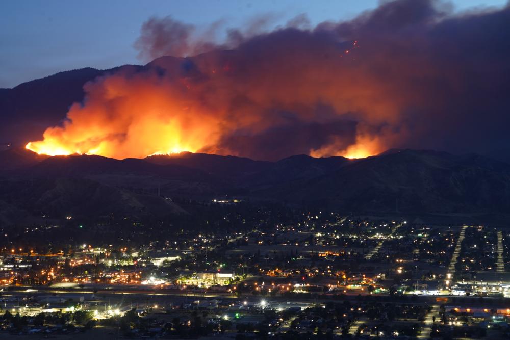 "Wildfires in 2021 emitted a record-breaking amount of carbon dioxide; Overhead photo of Apple Fire"
