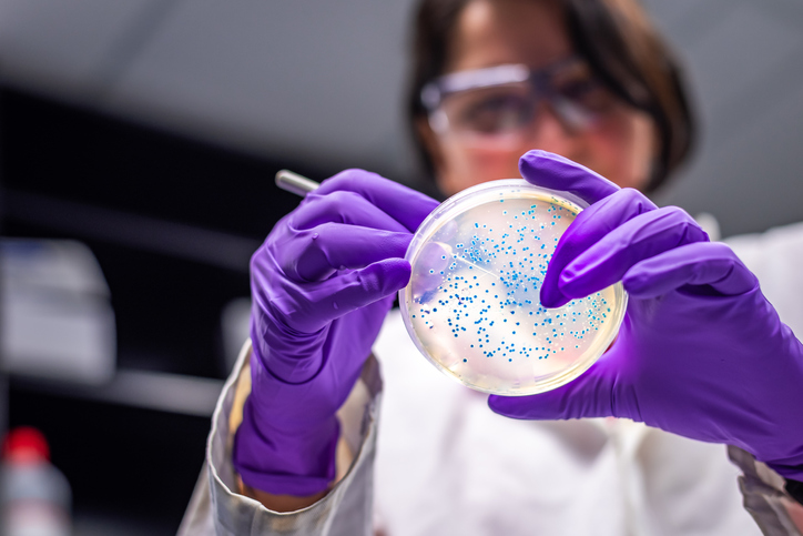 Woman with petri dish
