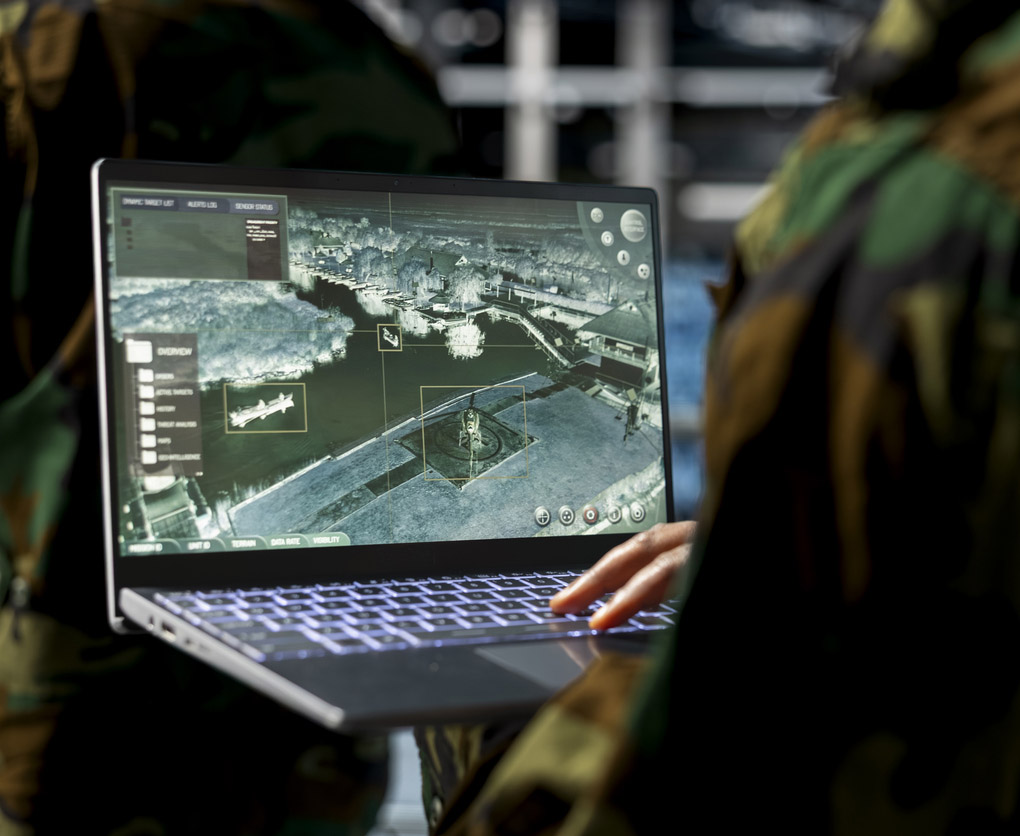 Military technician working on a laptop