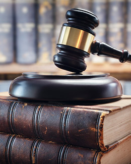 Judge's gavel resting on top of a stack of law books