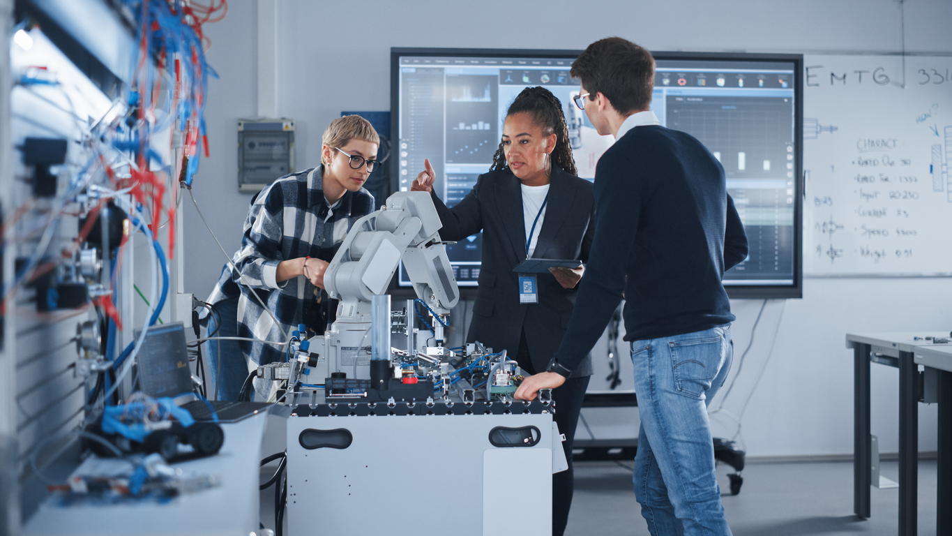 University researchers in a laboratory by a microscope