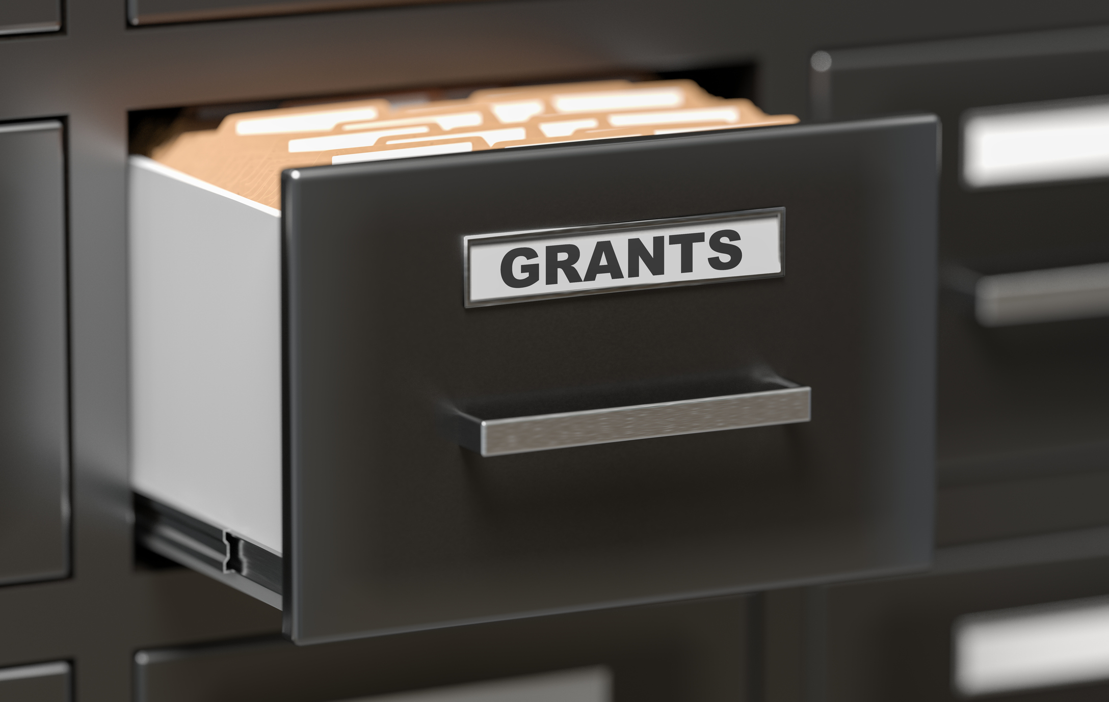 Black filing cabinet with drawer open showing grant-related files