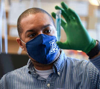 University researcher with a vial