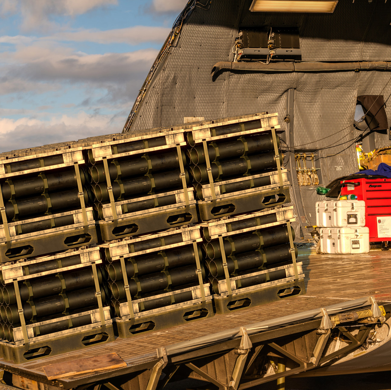Military cargo getting loaded onto heavy air transport