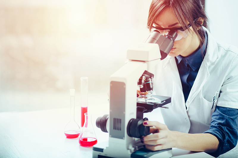Woman looking into microscope