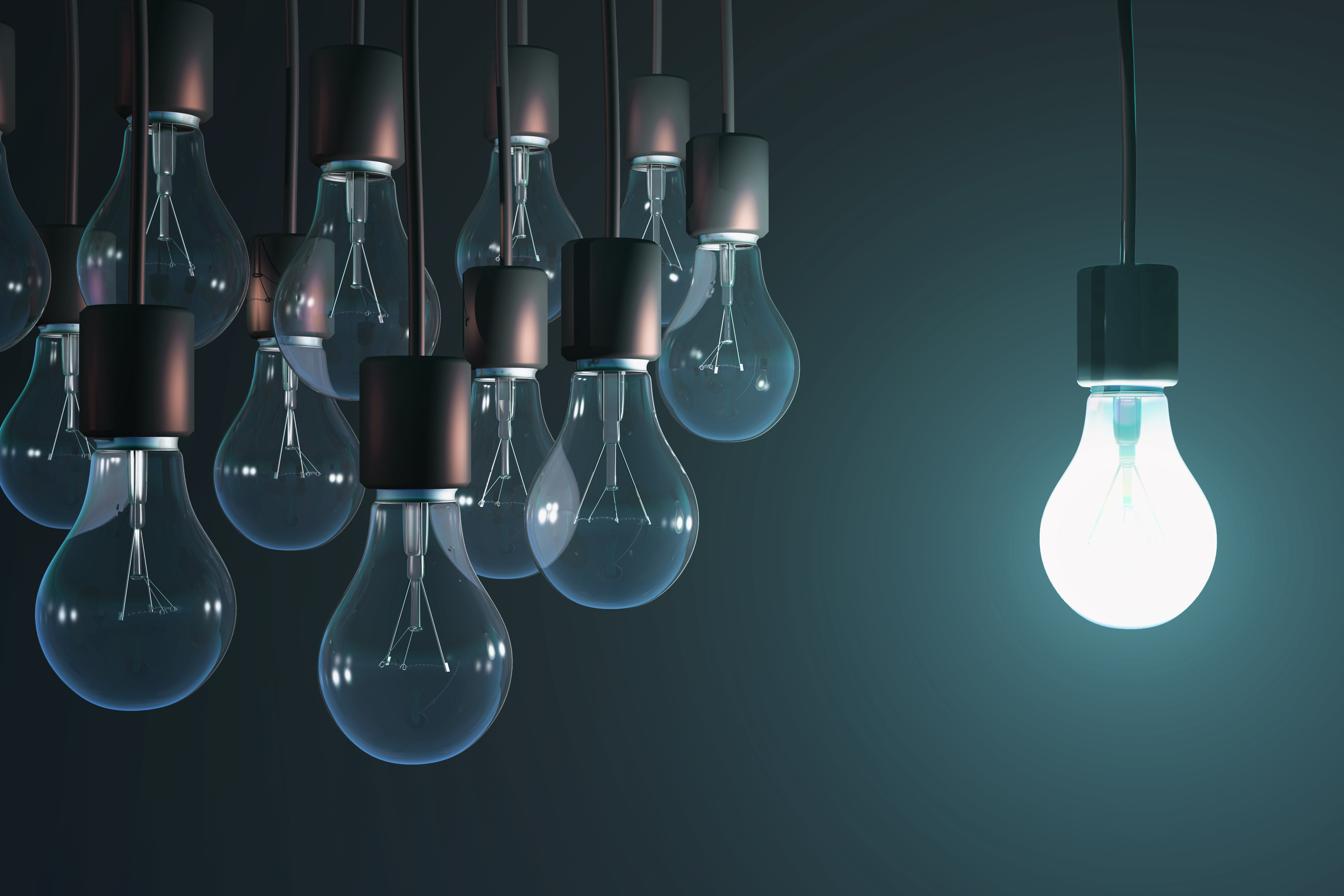 One lit bulb to the right of a group of unlit bulbs