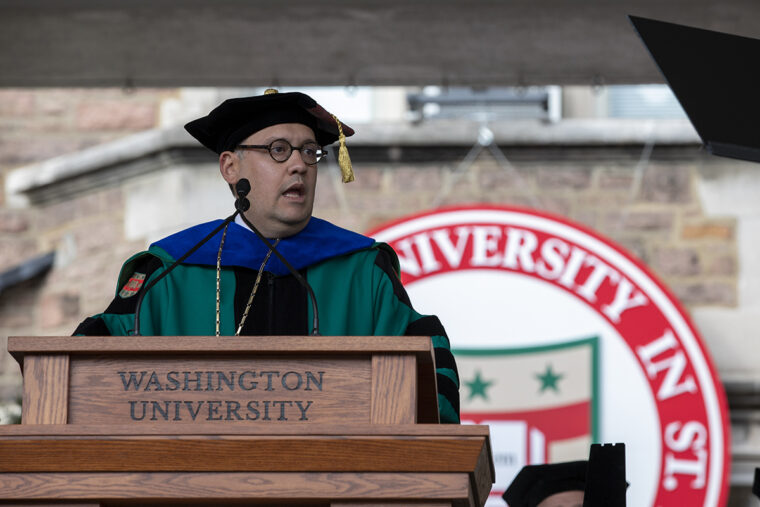 Chancellor Andrew Martin standing at a speech podium