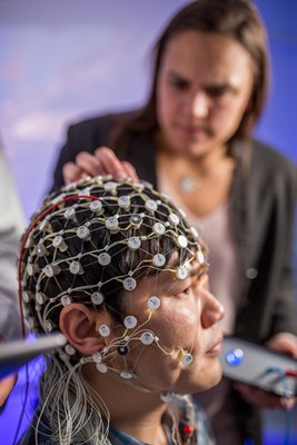 A researcher uses a device to study a participants brain. 