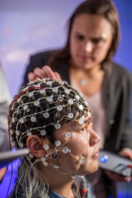 A researcher uses a device to study a participants brain.