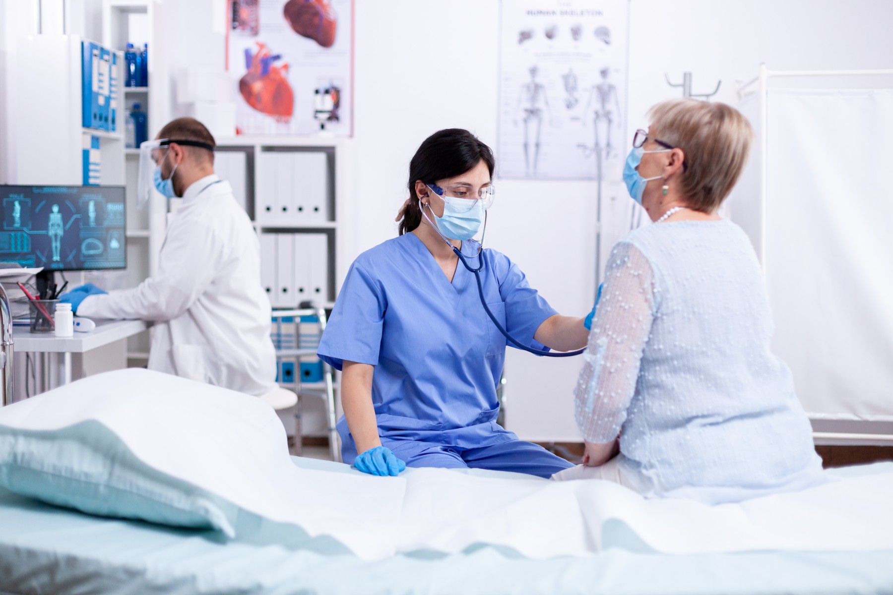 Doctor checking patients heart