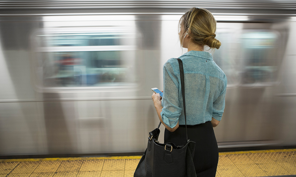 woman waiting for a train in motion