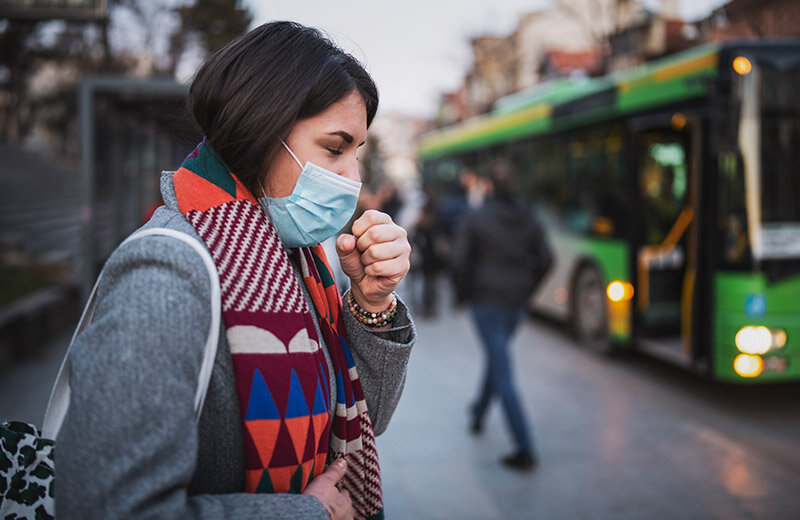 woman with cough and wearing mask
