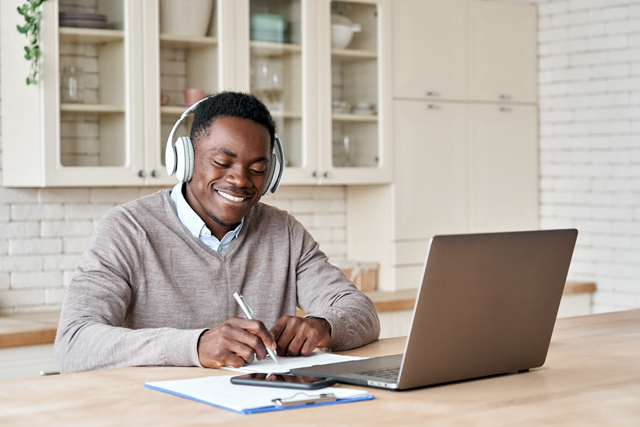 Man sitting at computer with headphones