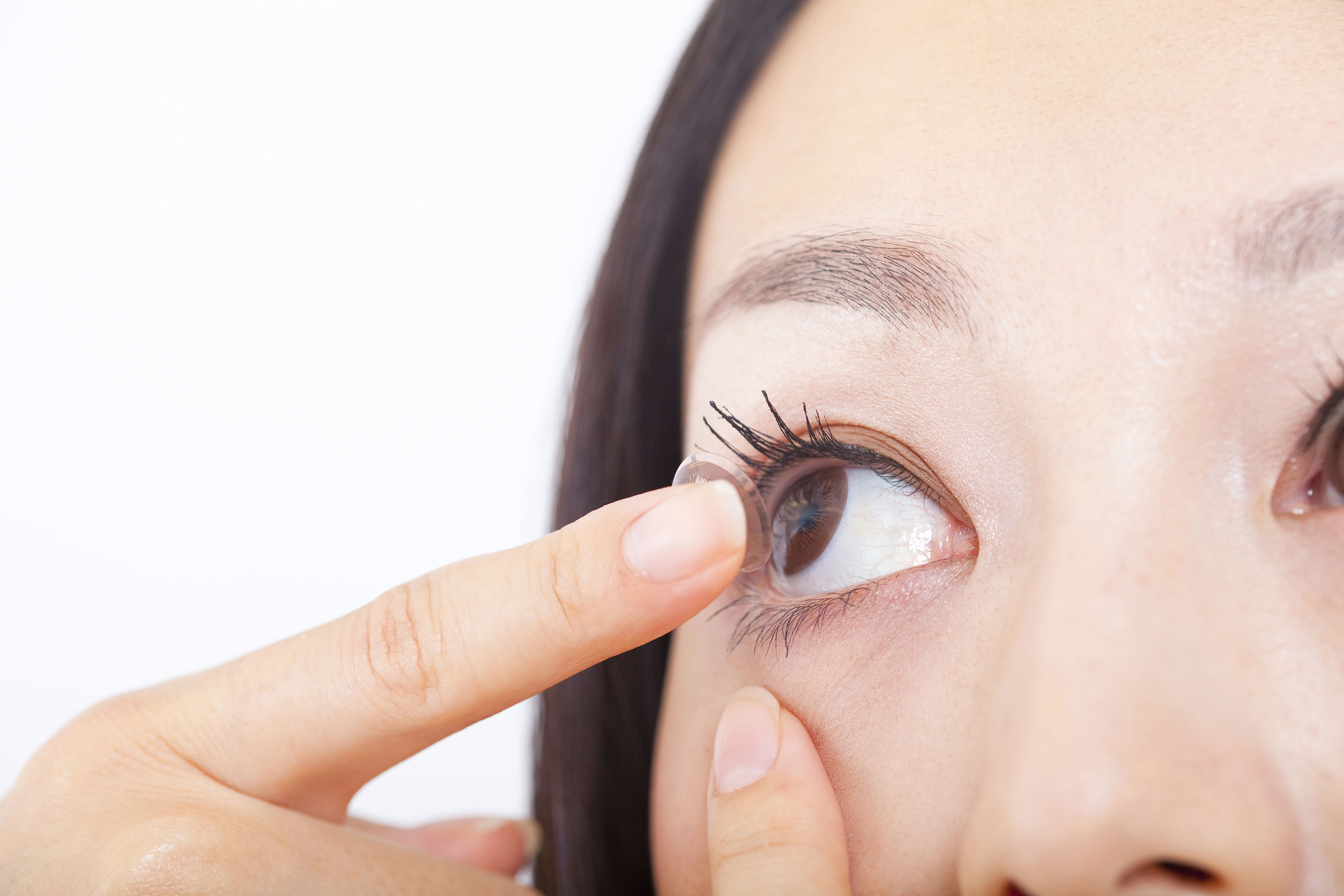 Person putting in a contact lens