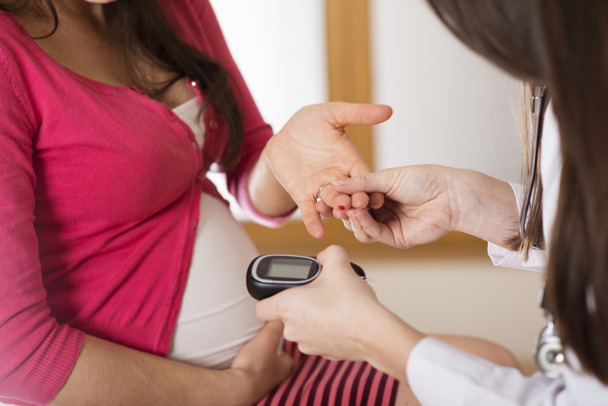 A pregnancy woman has her blood sugar tested.