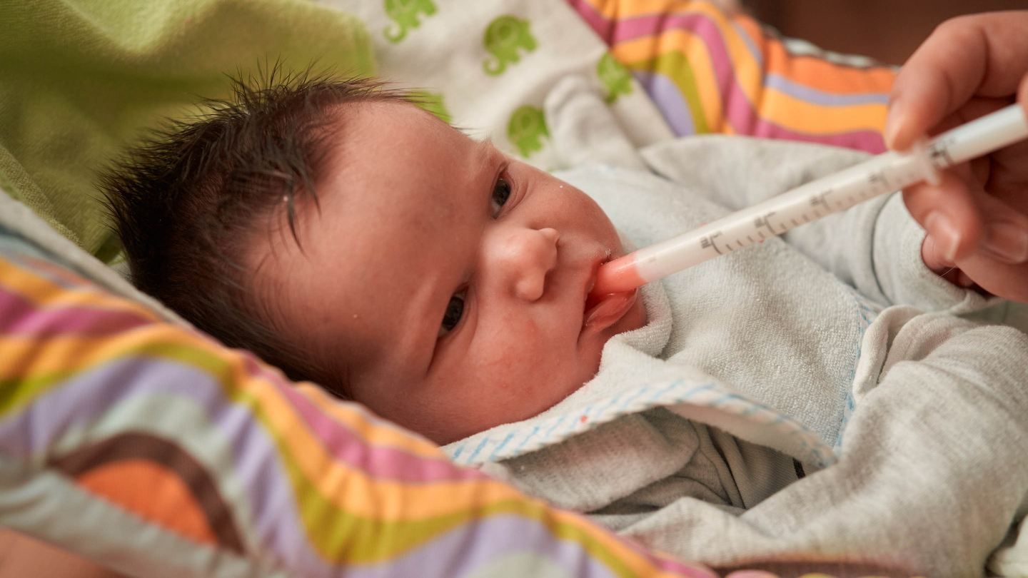 A baby being given a medicine
