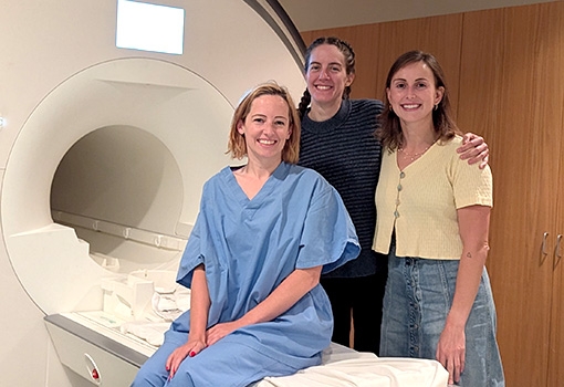 Lab technicians and patient at an MRI machine