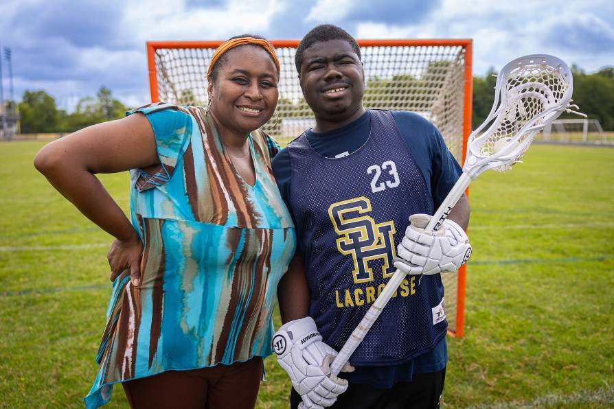 Ray Barrett on a LaCrosse field with his mother