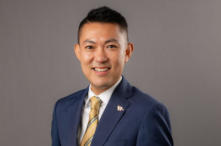 Picture of Alexandre Chan smiling and wearing a suit.